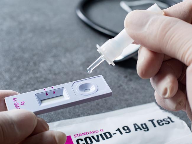 Holding sample tube keep the sample from Nosal cotton bud for a drop to Covid-19 standard q stick for fast test coronavirus in hospital. Home testing kid. Escape 26 March 23. Doc Holiday. Photo - iStock