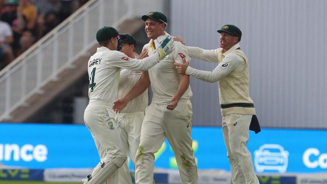 Australia's Cameron Green (C) celebrates with teammates after taking another screamer. PiIcture: AFP