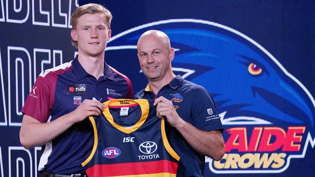 Fischer McAsey is presented with a Crows jumper by coach Matthew Nicks after being selected at the 2019 AFL draft. Picture: Michael Dodge/AAP