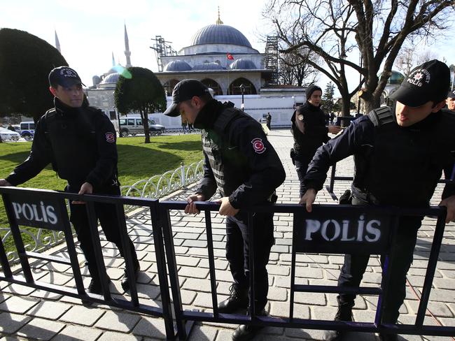 Containment ... policemen install security barriers at the historic Sultanahmet district, which is popular with tourists, after an explosion in Istanbul. Picture: AP