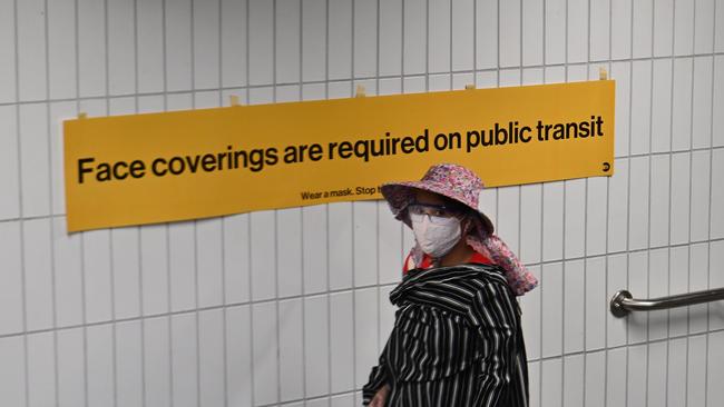 A woman enters a New York city subway station as the United States charts its six millionth case of the new coronavirus. Picture: AFP