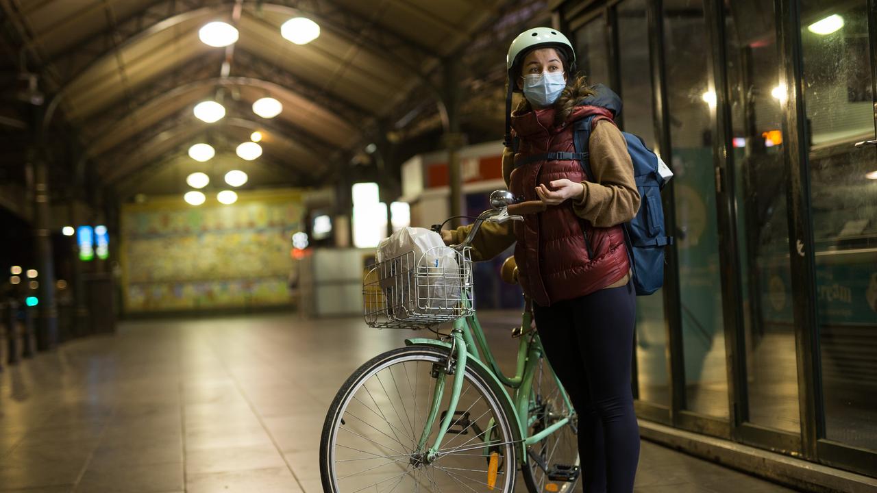 Turkish student Aynur Cargan had to walk her bike home with a flat tyre and hoped to be home before the 8pm curfew. Picture: Paul Jeffers/The Australian