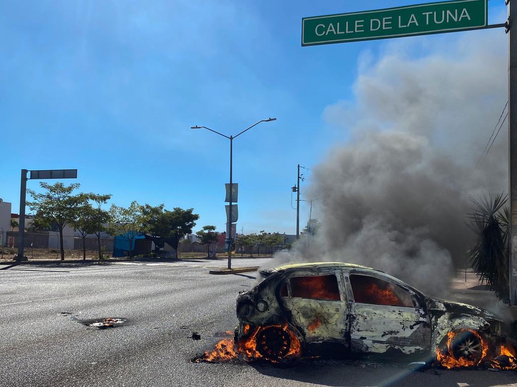 A burning car is seen on the street in Culiacan. Picture: Juan Carlos Cruz/AFP