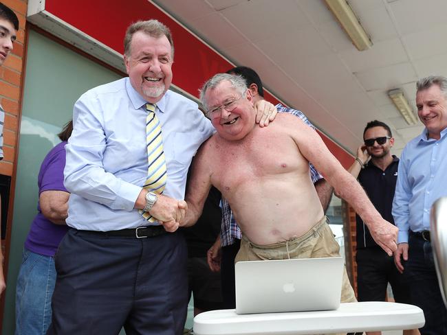 Goodna resident Frank Beaumont and Paul Tully listen to the flood inquiry judgment. Pic Peter Wallis