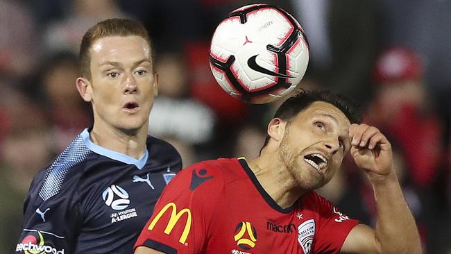 Adelaide United’s Mirko Boland heads the ball ahead of Sydney FC’s Brandon O’Neill on Friday night. Picture: Sarah Reed