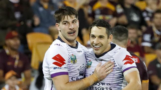 Billy Slater of the Storm celebrates with team mates after scoring a try during the Round 7 NRL match between the Brisbane Broncos and the Melbourne Storm at Suncorp Stadium in Brisbane, Friday, April 20, 2018. (AAP Image/Glenn Hunt) NO ARCHIVING, EDITORIAL USE