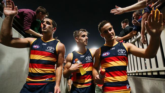 Taylor Walker, Jordan Galluci and Myles Poholke of the Crows walk down the tunnel during the round five AFL match between the Sydney Swans and the Adelaide Crows at Sydney Cricket Ground on April 20, 2018 in Sydney, Australia. (Photo by Brendon Thorne/Getty Images)