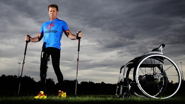 John Maclean who was a rugby league player before being hit by a car and put in wheelchair is about to compete in a triathlon after regaining some use of his legs. John stands up next to his wheelchair at Timbrell Park in Haberfield Sydney. Pic Brett Costello