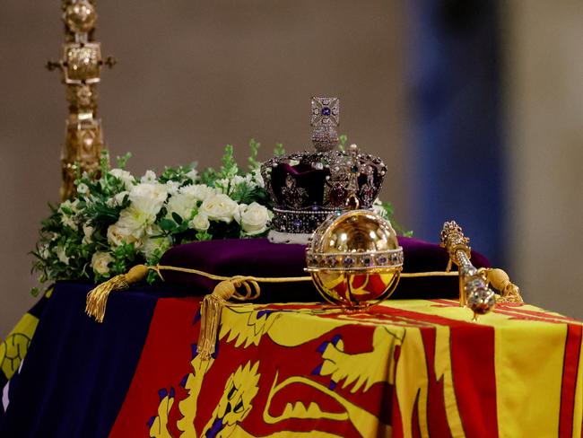 The coffin of Queen Elizabeth II, draped in a Royal Standard and adorned with the Imperial State Crown with the Imperial State Crown and the Sovereign's orb and sceptre. The world said its final farewell to Her Majesty on Monday night. Picture: Sarah Meyssonnier / Pool / AFP