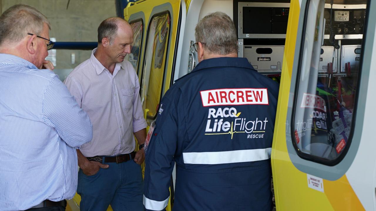 Stanley Paynter (centre) inspects the modern LifeFlight rescue choppers, flanked by LifeFlight Foundation Board director Mike Stewart and LifeFlight air crew officer Mark Arthur.