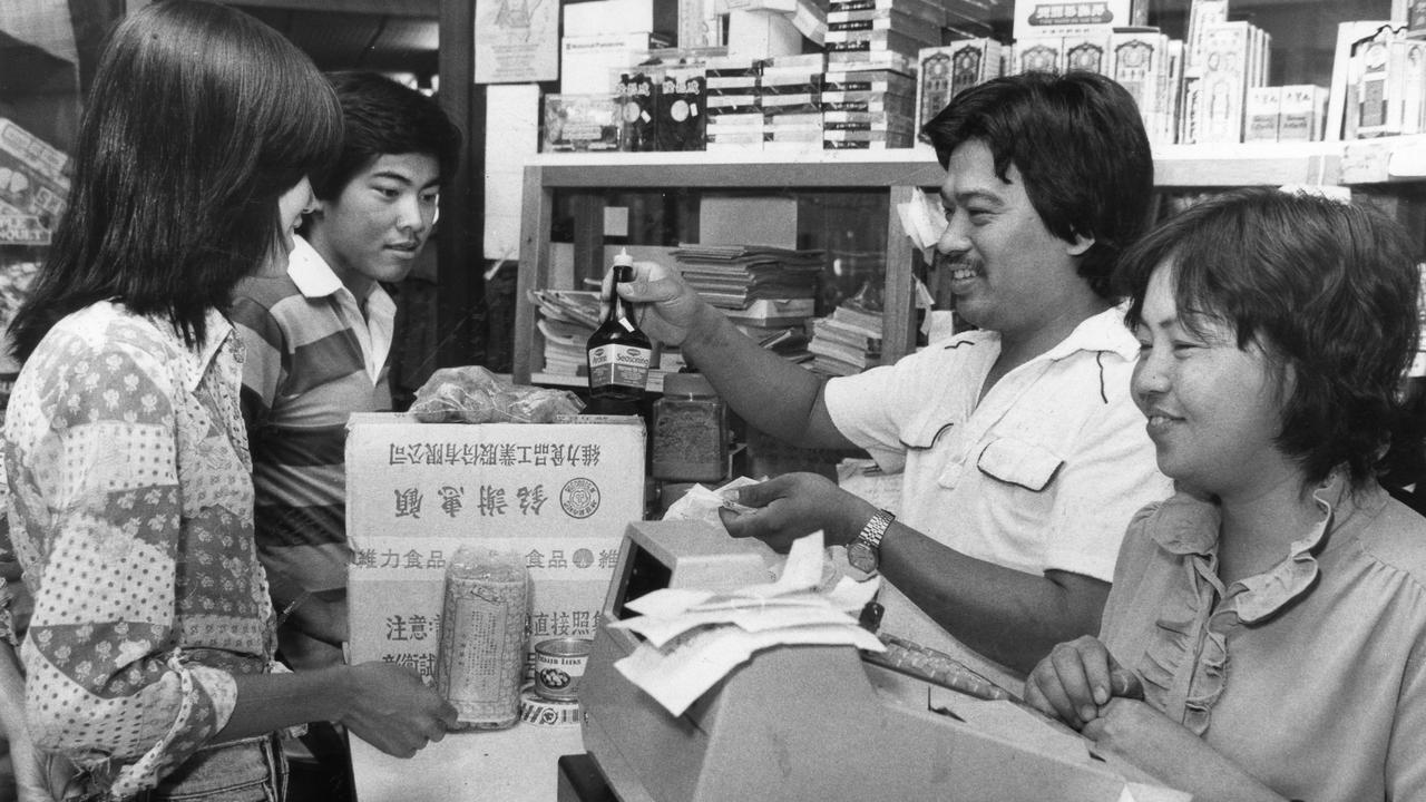 Vietnamese refugee Do Tu Hue and his wife Muoi serve customers in their The World Grocery store, 1983.