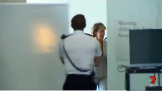 Following her comments, Jobs Minister Michaelia Cash attempted to avoid the media by hiding behind a white board on her way to Senate estimates. (Pic: 7 News)