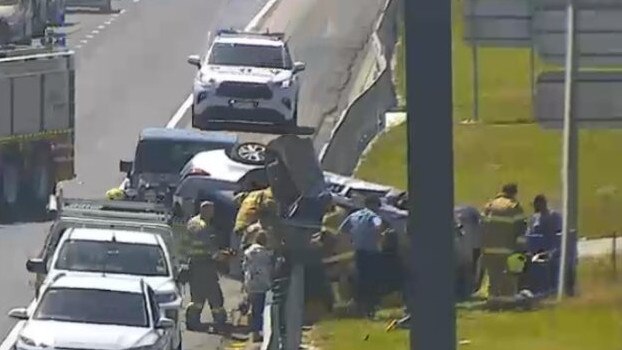 Emergency workers help the driver after the crash on the Monash Freeway on Wednesday morning. Picture: VicTraffic