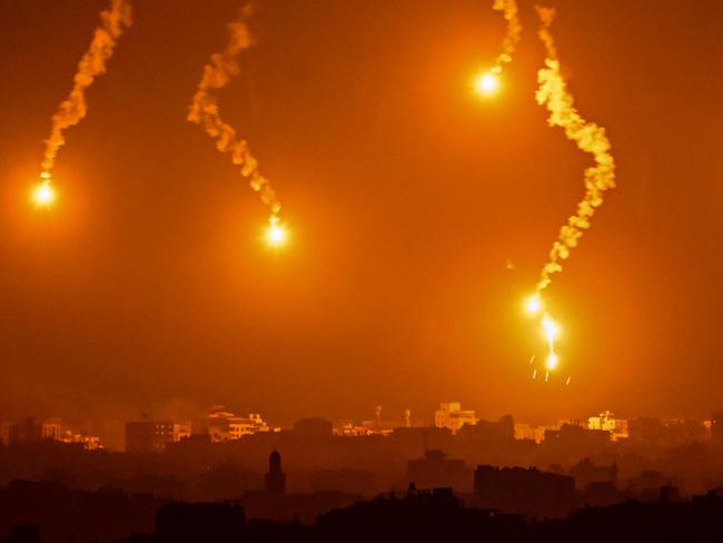 Israeli flares light up the sky as they drop onto the Gaza Strip. Picture: Aris Messinis/AFP