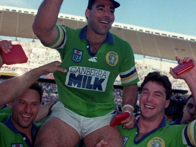 Canberra Raiders players Laurie Daley &amp; Bradley Clyde hoist captain Mal Meninga after Grand Final win against Canterbury in 1994.