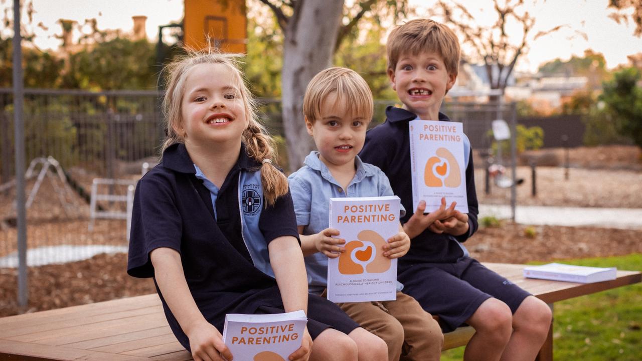 Dr. Terence Sheppard, a renowned author and pediatric psychologist, is pictured with children holding the Positive Parenting book he co-authored with his wife, Margaret Kummerow. Picture: Remco Albers @ MILCO.