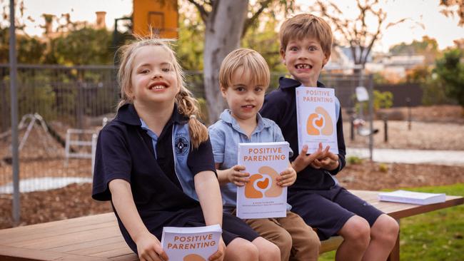 Dr. Terence Sheppard, a renowned author and pediatric psychologist, is pictured with children holding the Positive Parenting book he co-authored with his wife, Margaret Kummerow. Picture: Remco Albers @ MILCO.