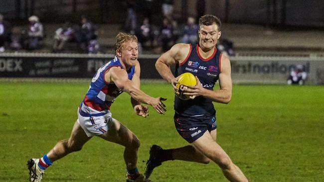 Bulldog Travis Schiller chases Redlegs midfielder Cole Gerloff at Norwood Oval. Picture: Matt Loxton