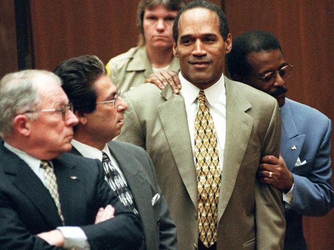 Johnnie Cochran Jr (R) holds onto his client, former actor and NFL star OJ Simpson, with F Lee Bailey and Robert Kardashian, as the not guilty verdict is read in 1995. Picture: Supplied