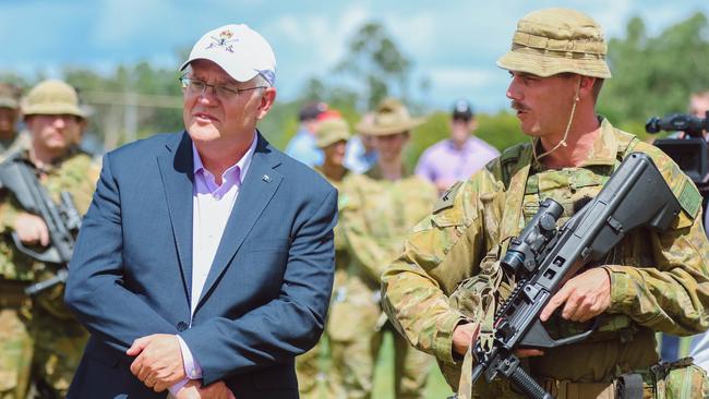 Prime Minister Scott Morrison with Corporal Paul Siedel as he visits Australian and American personnel at Darwin's Robertson Barracks. Picture Glenn Campbell