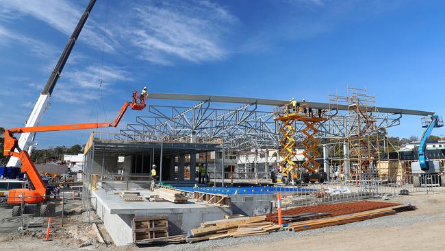 Roofing sections being lifted into place at the community hub in the Kingston Park development. Picture: SAM ROSEWARNE