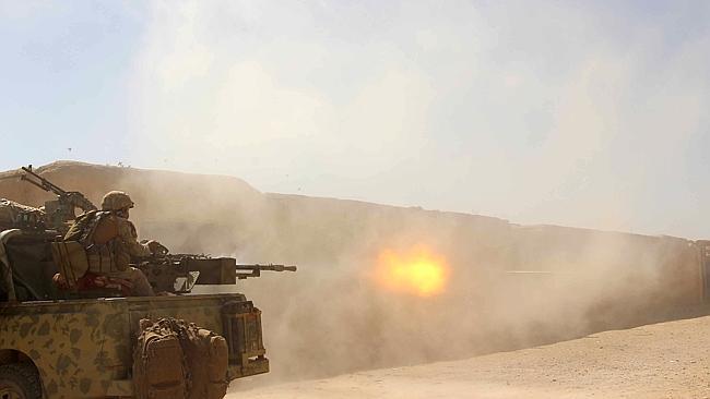 Afghan National Army commandos open fire on a Taliban position during a military operation in Helmand province.