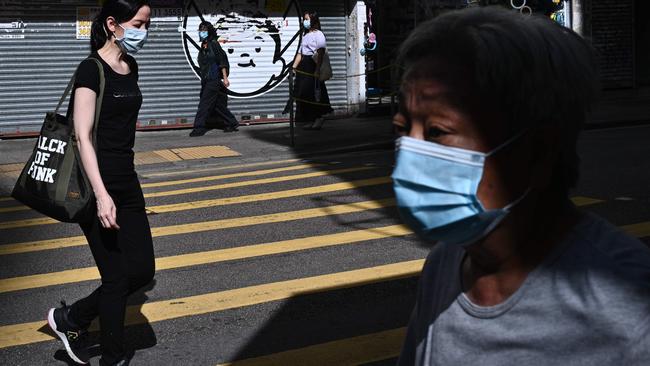 Pedestrians in Hong Kong on Monday as masks become mandatory. Picture: AFP