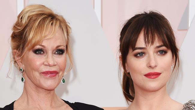 HOLLYWOOD, CA - FEBRUARY 22: Actresses Melanie Griffith (L) and Dakota Johnson attend the 87th Annual Academy Awards at Hollywood & Highland Center on February 22, 2015 in Hollywood, California. (Photo by Jason Merritt/Getty Images)