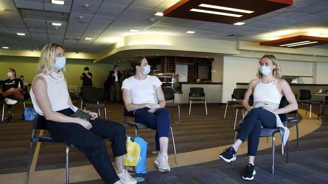 Australia swimmers Bronte and Cate Campbell and Ariarne Titmus waiting for their COVID-19 jab. Picture: Josh Woning