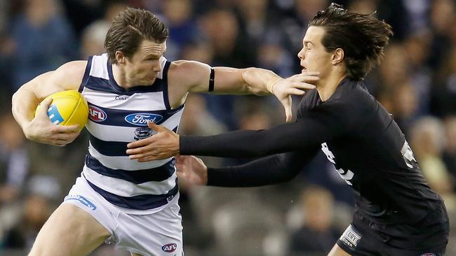 Patrick Dangerfield fends Jack Silvagni off last year.