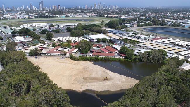 Workers move earth at Black Swan Lake at Bundall. Picture Glenn Hampson.