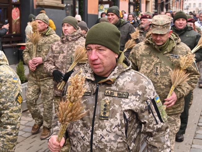 Ukrainian servicemen carry bundles of wheat as they take part in the celebrations on Christmas Eve in the western Ukrainian city of Lviv. Picture: AFP