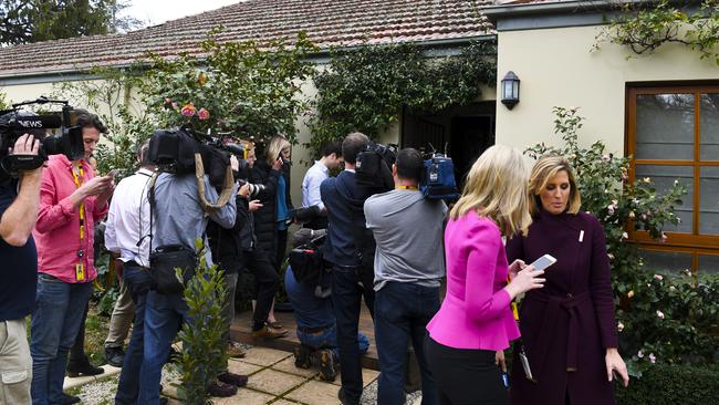 Members of the media are seen waiting outside a house. Picture: AAP