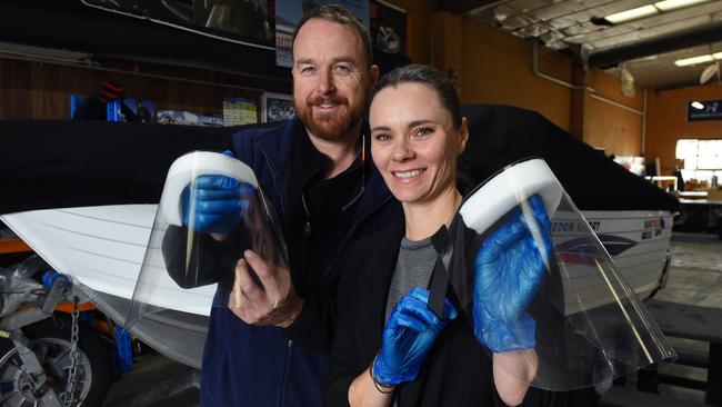 Bayswater company Cover Craft have gone from making boat covers to Personal Protective Equipment face shield production. Owners Scott and Brigitte Easton with the shields. Picture: Josie Hayden