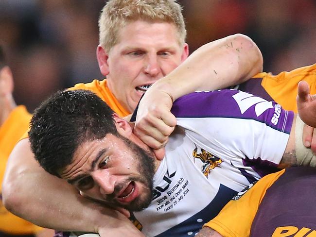 BRISBANE, AUSTRALIA - JULY 25: Jesse Bromwich of the Storm is tackled by Ben Hannant and Andrew McCullogh of the Broncos during the round 20 NRL match between the Brisbane Broncos and the Melbourne Storm at Suncorp Stadium on July 25, 2014 in Brisbane, Australia. (Photo by Chris Hyde/Getty Images)