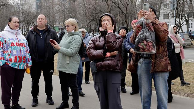 People react outside a damaged apartment building following the drone attack. Picture: AFP