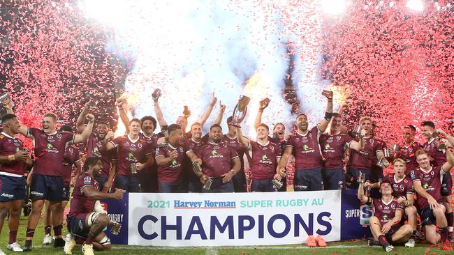 The Reds celebrate with the trophy after winning the Super RugbyAU final last year. Photo: Getty Images