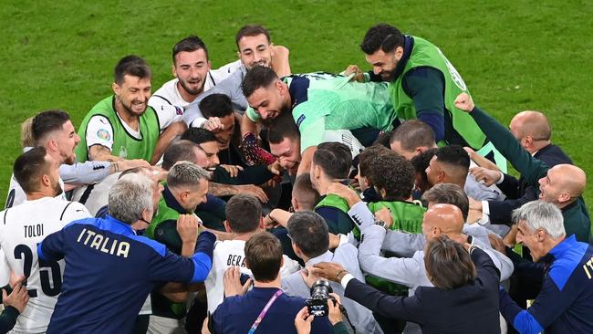 Italy players and staff huddle to celebrate victory over Belgium. Picture: AFP