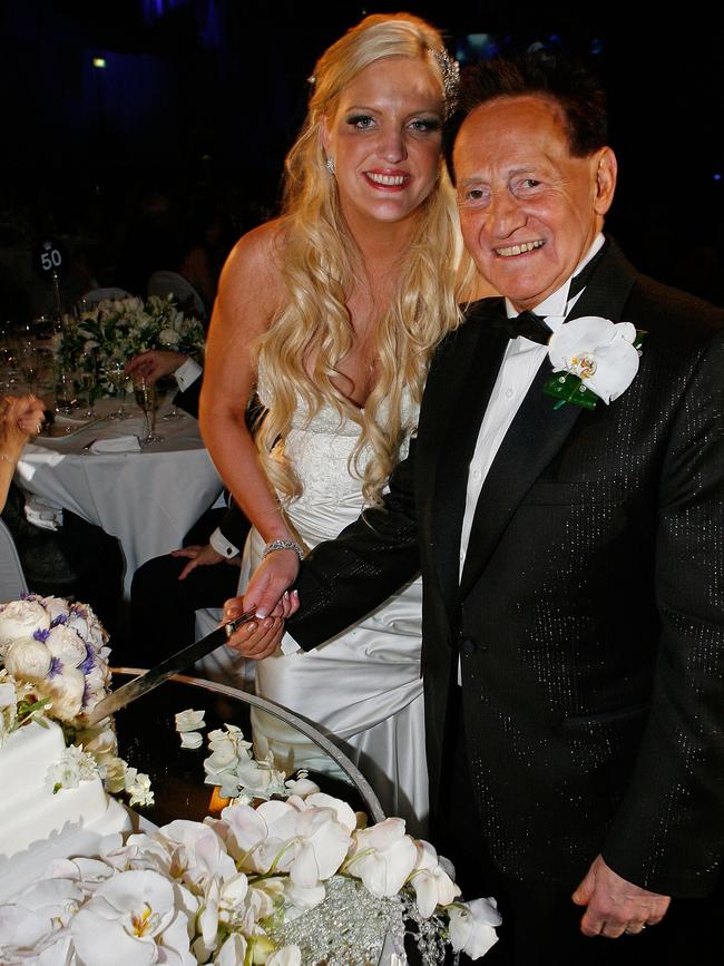 Brynne Gordon and Geoffrey Edelsten pose for a photograph as they cut their wedding cake in 2009.