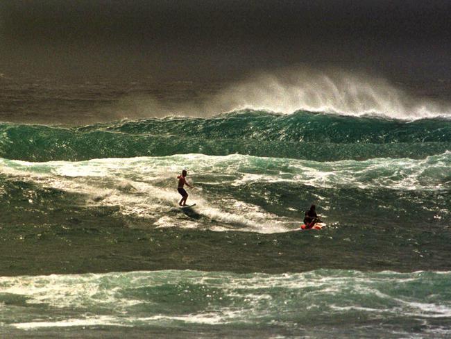 1998: Surfboard rider being towed by a jet ski at Kirra.