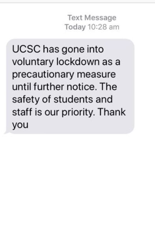 A text message from Upper Coomera State College to parents notifying the school has gone into voluntary lockdown following threats of a shooting.