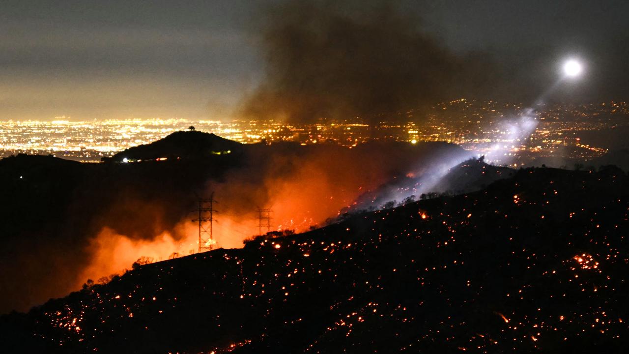 Firefighters race to beat LA blazes as winds grow