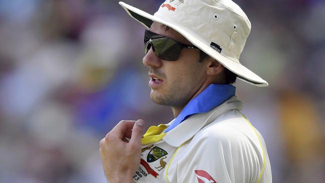 Australia's Pat Cummins tries to cool himself while fielding. Picture: AP.