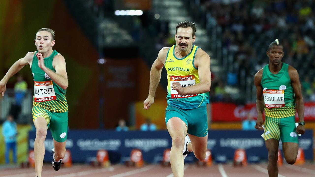 Charl du Toit of South Africa, Evan O'Hanlon of Australia and Union Sekailwe of South Africa racing the T38 100m final at the Commonwealth Games.