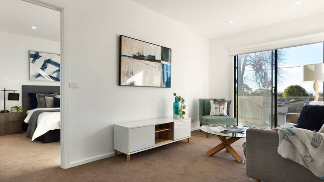 The upstairs main bedroom flows into a retreat with a balcony.