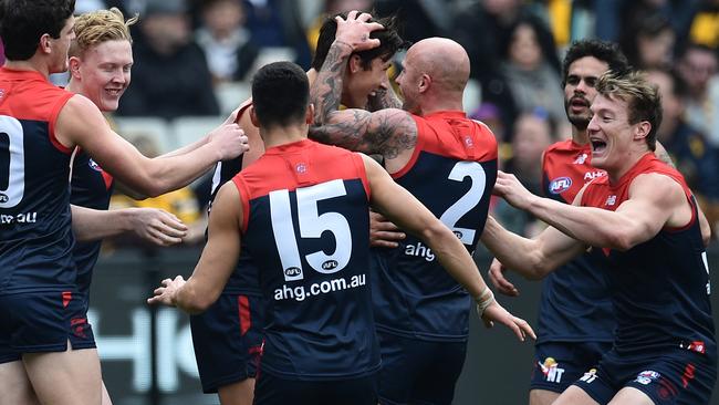 Sam Weideman (fourth from left) i s embraced by teammates after he kicked his first AFL goal during the Round 20 AFL match between the Melbourne Demons and the Hawthorn Hawks at the MCG in Melbourne, Saturday, Aug. 6, 2016. (AAP Image/Julian Smith) NO ARCHIVING, EDITORIAL USE ONLY