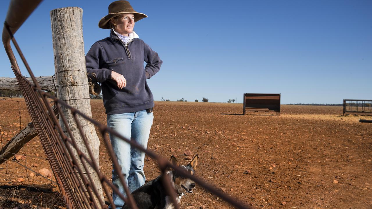 Candice Roberts with her dog Tricky on her drought-stricken sheep property Victoria Downs Station in western Queensland. “If we don’t get rain over the summer, things will get very difficult for us,’’ Ms Roberts says. July, 2018. Picture: Lachie Millard