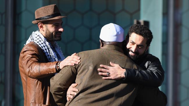 Linwood Islamic Centre Imam Alabi Lateef Zirullah, centre, is greeted by Al Noor Mosque shooting survivor Wasseim Alsati, right as he arrives for the sentencing of Brenton Tarrant. Picture: Getty