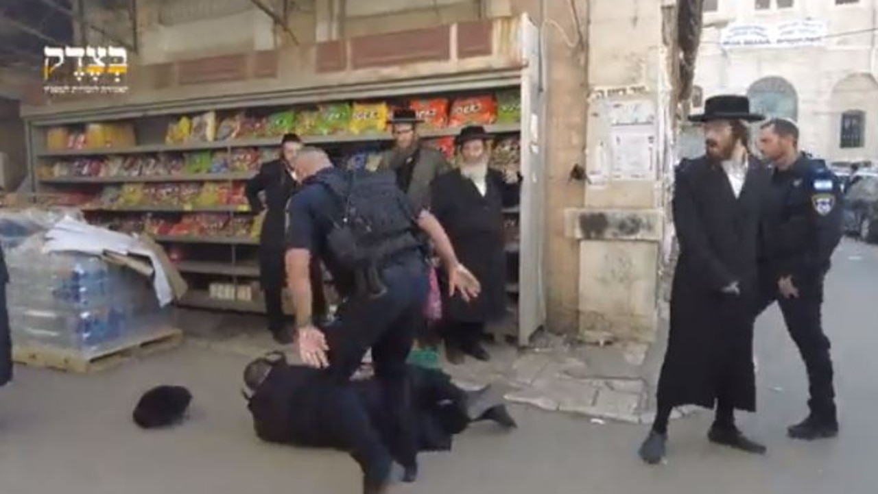 A Jewish man is knocked to the ground by a police officer. Picture: X/Quds News Network