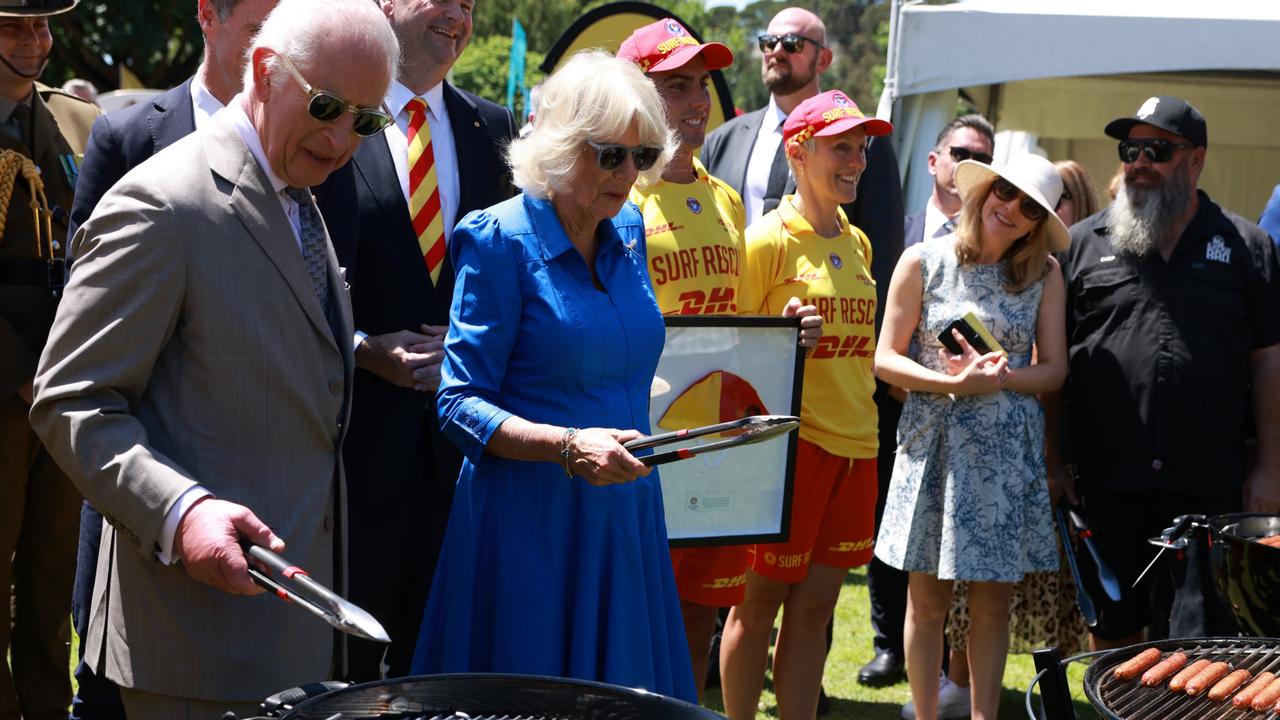 King Charles and Queen Camilla cook sausages during the Premier's community barbecue at Parramatta Park. Picture: Ian Vogler-Pool/Getty Images